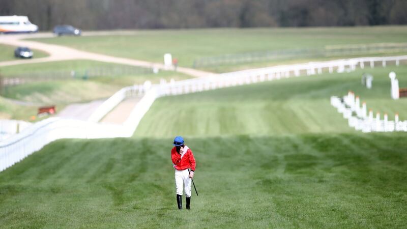 Jack Kennedy walks back along the course after falling from Envoi Allen. Photo: Tim Goode/PA Wire