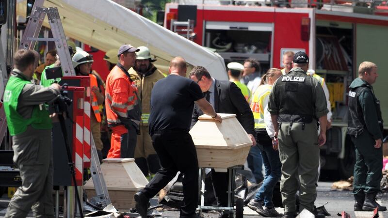 Undertakers bring coffins to the site of the bus crash on the A9 highway near Muenchberg, southern Germany. Photograph: Nicolas Armer /AFP/Getty Images