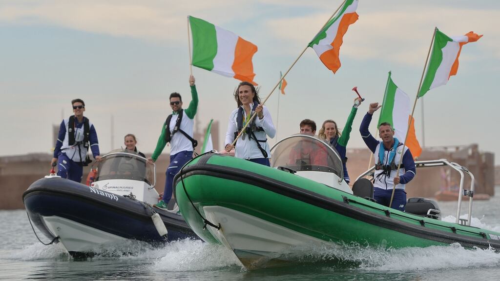 Olympic siver medal winner Annalise Murphy arrives in Dún laoghaire harbour on a flotilla of boats containing other members of the Irish Olympic sailing team. Photograph: Alan Betson/The Irish Times