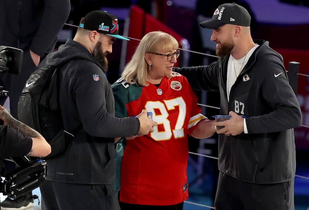 Donna Kelce gives cookies to her son's Jason (left) of the Philadelphia Eagles and Travis of the Kansas City Chiefs during Super Bowl LVII opening night in Phoenix, Arizona. Photograph: Christian Petersen/Getty Images