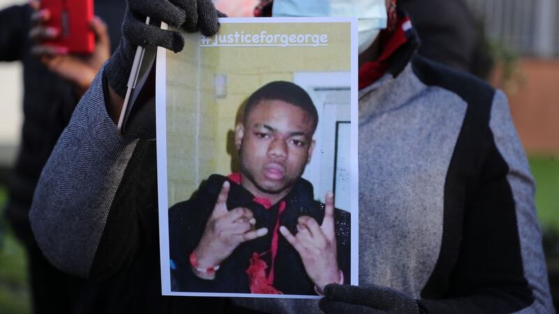A person holds a photo of George Nkencho. File photograph: Nick Bradshaw