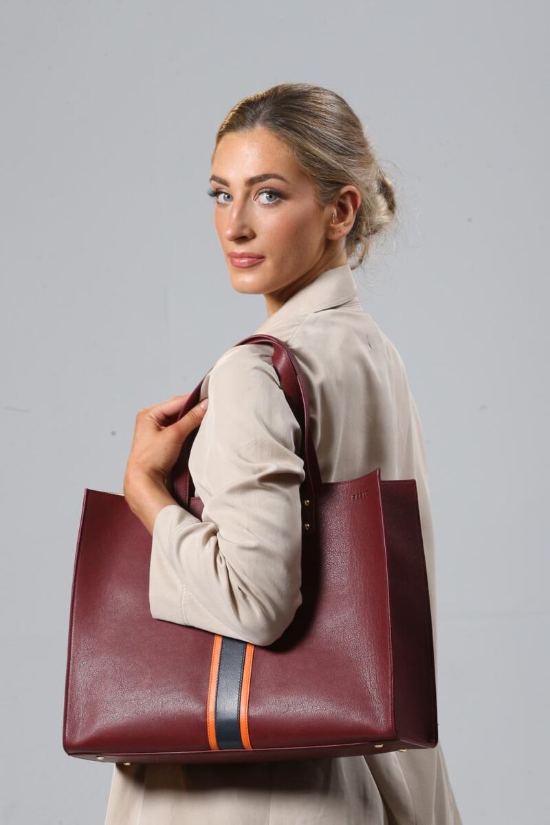 Large striped tote in Italian leather with orange stripe and magnetic closure (€265), by Julie Peelo