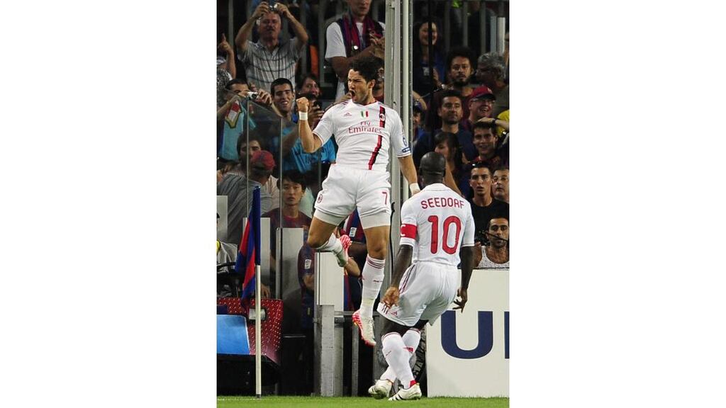 AC Milan's Pato, left, reacts after scoring against FC Barcelona during a Champions league soccer match at the Nou Camp stadium in Barcelona, Spain. - (AP Photo/Manu Fernandez)