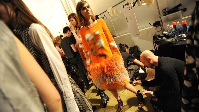 Last touches are made to leg make-up at the Peter Som show at Milk Studios on the second day of Mercedes-Benz
Fashion Week in New York, Feb. 7, 2014. (Jennifer S. Altman/The New York Times)