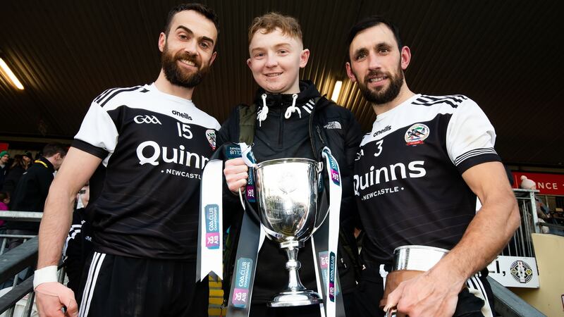 Caelan McEvoy with Kilcoo’s joint captains Conor Laverty and Aidan Branagan after the Ulster SFC final win over Donegal’s Naomh Conaill in Omagh. Photograph: Evan Logan/Inpho