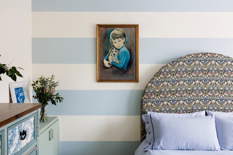 A guest bedroom has been treated to makeover courtesy of an upholstered headboard