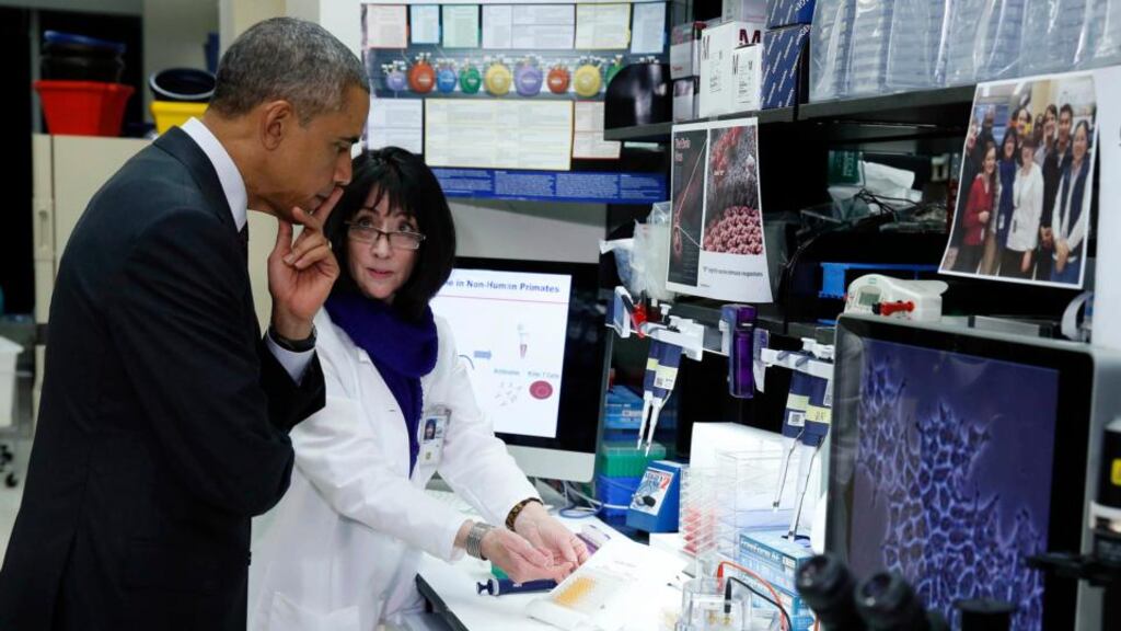 US president Barack Obama tours a lab with senior researcher Nancy Sullivan to talk about Ebola while he visits the National Institutes of Health in Maryland. Photograph: Larry Downing/Reuters