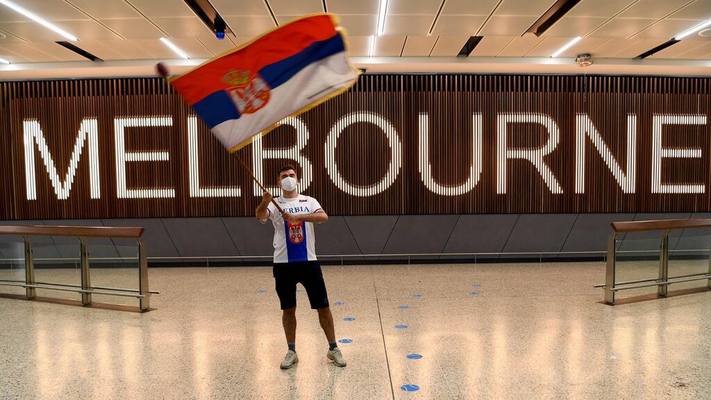 A Serbian tennis fan waves a flag as he awaits the arrival of Novak Djokovic in Melbourne. Photograph: William West/AFP/via Getty Images