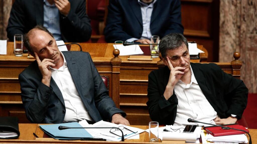 George Stathakis, Greece’s economy minister, and finance minister Euclid Tsakalotos, await the vote in parliament: in the last two bailout-related parliamentary votes, a quarter of Syriza MPs withheld their support from the government. Photograph: Yorgos Karahalis/Bloomberg