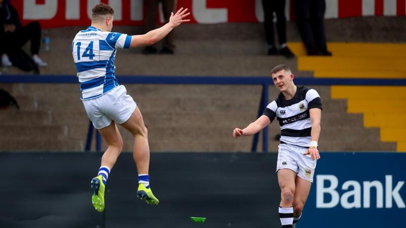 PBC’s Louis Bruce takes a kick as Jack Hunt of Rockwell attempts a block during the Munster Schools Senior Cup quarter-final at Musgrave Park. Photograph: Oisín Keniry/Inpho