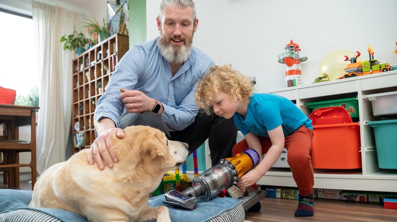 Paul Barker helps his youngest son use the hair screw tool to keep Holly’s bed spic and span