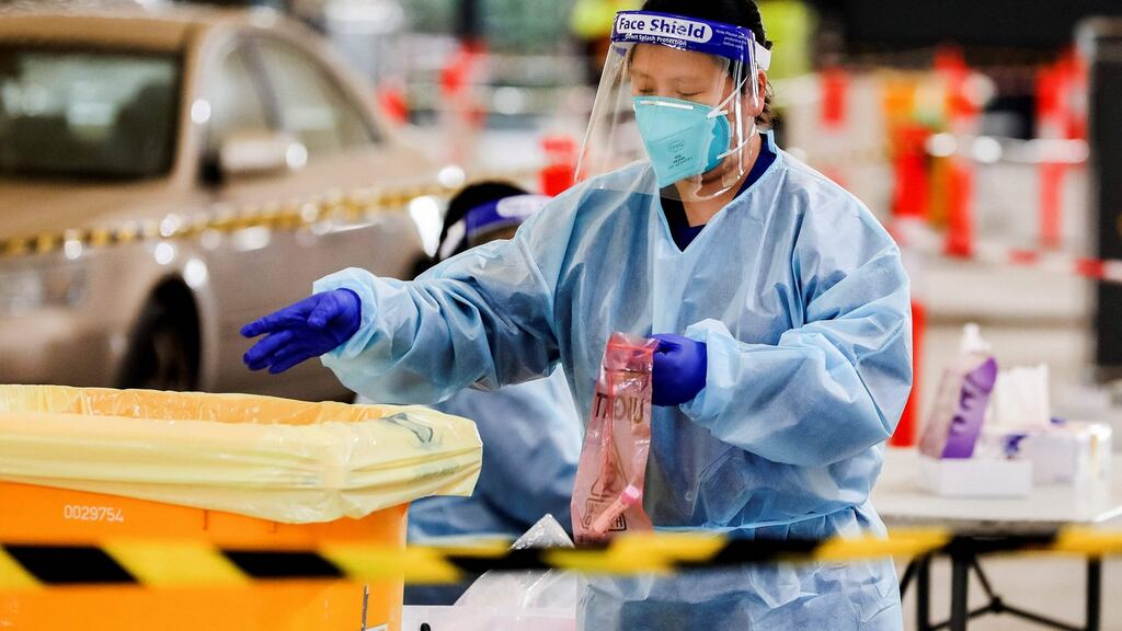 A health worker handles samples at a Covid-19 drive-through testing facility in Melbourne after Australia’s second largest city entered a fresh lockdown amid a resurgence in coronavirus cases. Photograph:y Asanka Brendon Ratnayake / AFP/Getty Images