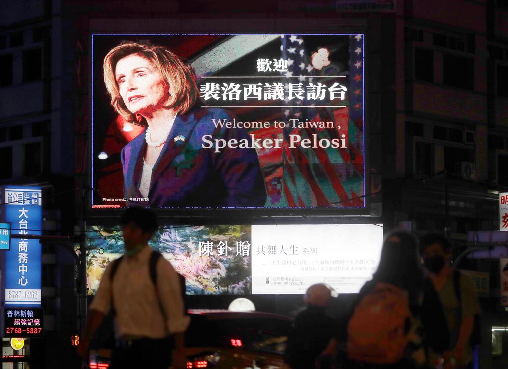People walk past a billboard welcoming US house speaker Nancy Pelosi in Taipei (AP)