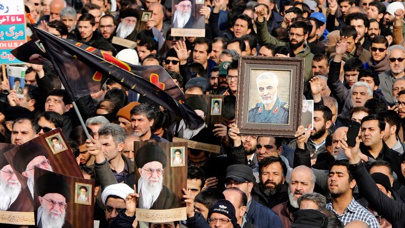 Iranians holding pictures of assassinated general Qassem Suleimani and supreme leader Ali Khamenei protest in Tehran on Friday over the US air strike that killed Suleimani. Photograph: Abedin Taherkenareh/EPA
