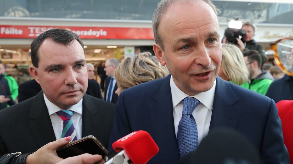 Fianna Fáil leader Micheál Martin and candidate James Collins speak to the media while on a general election canvass at Crescent Shopping Centre in Limerick City.  Photograph: Niall Carson/PA Wire