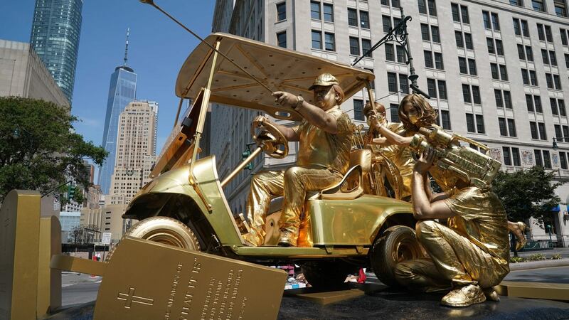 The Final Push living statute is unveiled in Battery Park in New York this week. The art depicts US president Donald Trump riding a golf cart over coronavirus and military tombstones while being filed by Fox News. Photograph: Bryan R Smith / AFP/ Getty Images