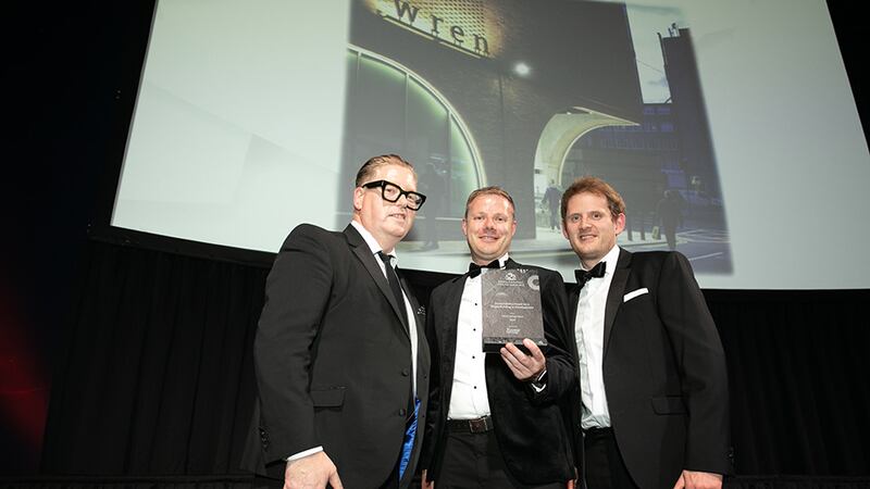Gerard de Brún, Director, Fiontar Group, presents the Sustainability Award for a Single Building or Development award to Michael Mullen and Patrick Kavanagh, BDP.