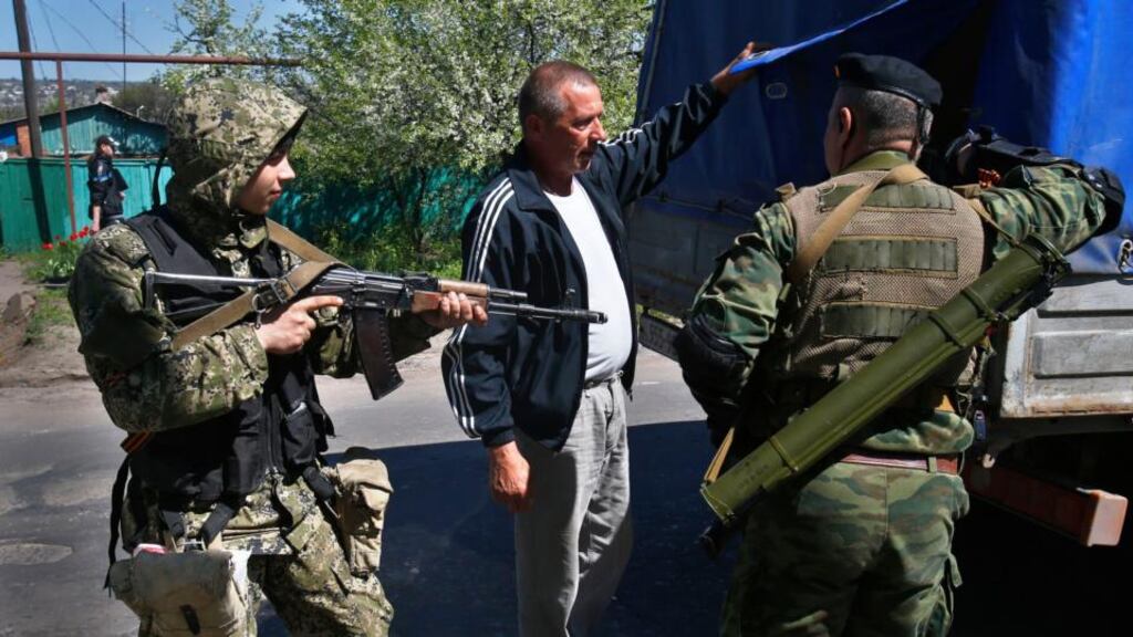 Pro-Russian armed militants inspect a truck near Slovyansk in eastern Ukraine yesterday. Photograph: AP Photo/Sergei Grits