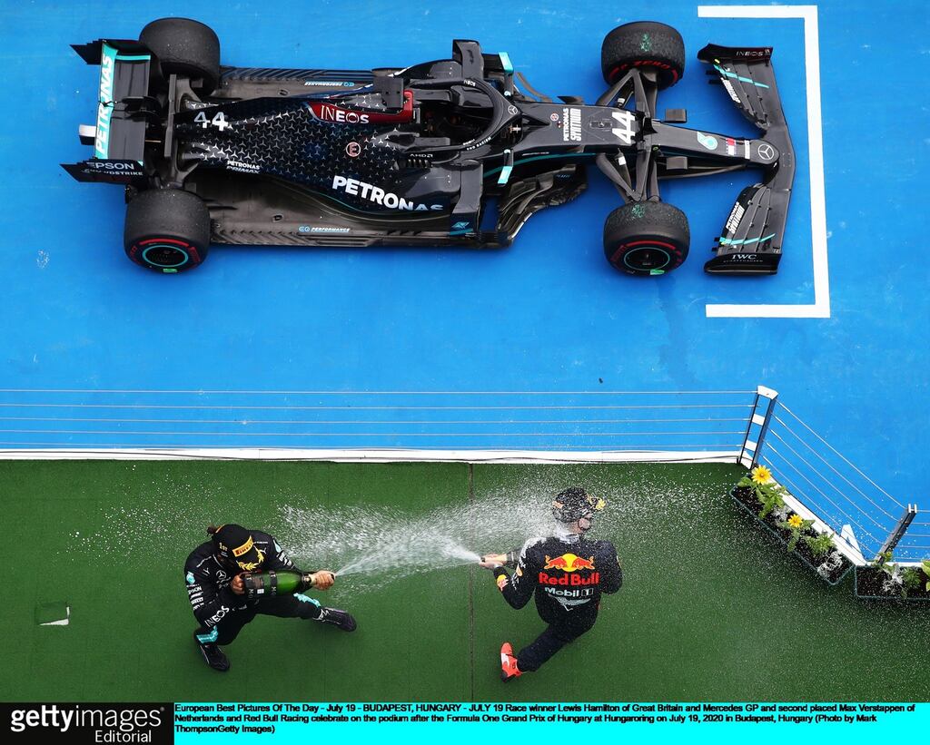 European Best Pictures Of The Day - July 19 - BUDAPEST, HUNGARY - JULY 19: Race winner Lewis Hamilton of Great Britain and Mercedes GP and second placed Max Verstappen of Netherlands and Red Bull Racing celebrate on the podium after the Formula One Grand Prix of Hungary at Hungaroring on July 19, 2020 in Budapest, Hungary. (Photo by Mark Thompson/Getty Images)