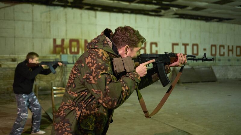 Teenagers and children get shooting instructions from members of a paramilitary group called Self Defense Mariupol,  in Mariupol, Ukraine. Photograph: Pierre Crom/Getty Images