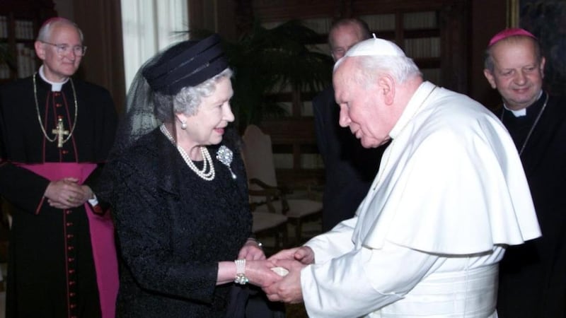 Britain’s Queen Elizabeth II meets Pope John Paul II during an audience at the Vatican in Rome in 2000. File Photograph: PA Wire