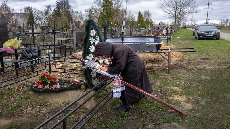 Valentyna Nechyporenko (77) weeps at the gravesite of her son Ruslan Nechyporenko (47) in Bucha, Ukraine. His body was found in Bucha after Russian soldiers withdrew weeks before, one of at least 700 murdered civilians found in towns around Kyiv, according to authorities. Photograph: John Moore/Getty Images