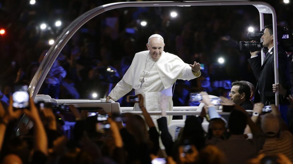 Pope Francis waves to the crowd during a parade in Philadelphia on Saturday night. Photograph: Matt Rourke/EPA