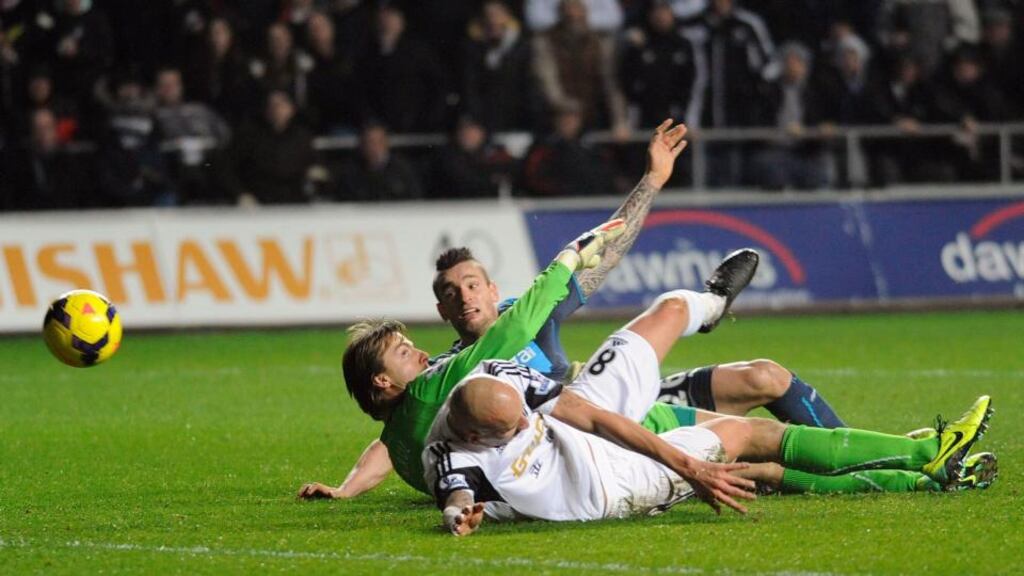 Jonjo Shelvey (8) scores Swansea’s thrid goal against Newcastle United’s goalkeeper Tim Krull (C) during their English Premier League soccer match at the Liberty Stadium. Photograph: Reuters.