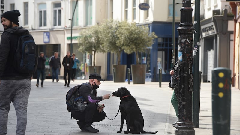 Feeding the dog on Grafton Street. Photograph: Dara Mac Dónaill