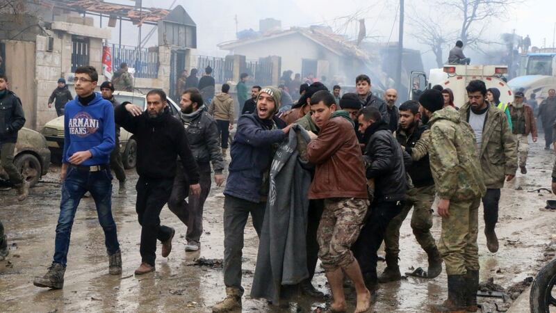 Rescue workers attend to those injured after they and Syrian’s opposition activists say dozens were killed when the car bomb went off. Photograph: Saif Alnajdi/AP