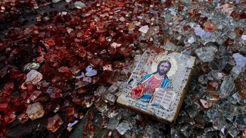 A bloodstained icon of Jesus is seen among shattered glass atop a wrecked Kamaz truck near the Donetsk airport. Photograph: Yannis Behrakis/Reuters