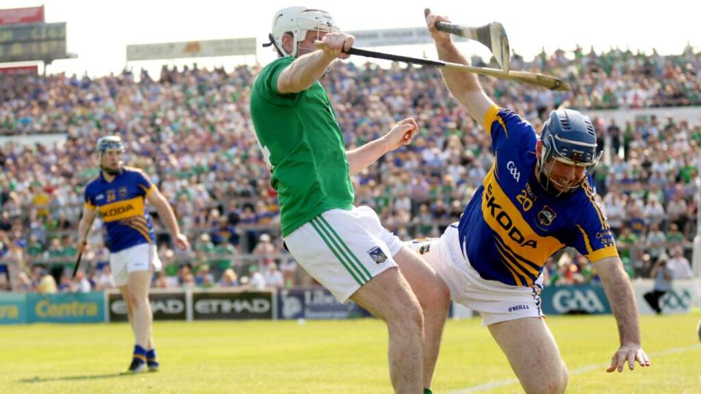 Tipperary’s Eoin Kelly feels the full force of a challenge from Limerick’s Tom Condon  during the Munster semi-final  at the Gaelic Grounds Photo: James Crombie/Inpho