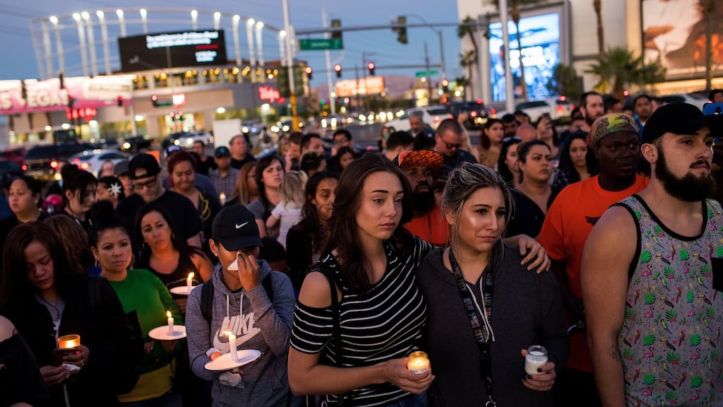 Mourners attend a candlelight vigil at the corner of Sahara Avenue and Las Vegas Boulevard for the victims of Sunday night’s mass shooting. Photograph: Drew Angerer/Getty Images