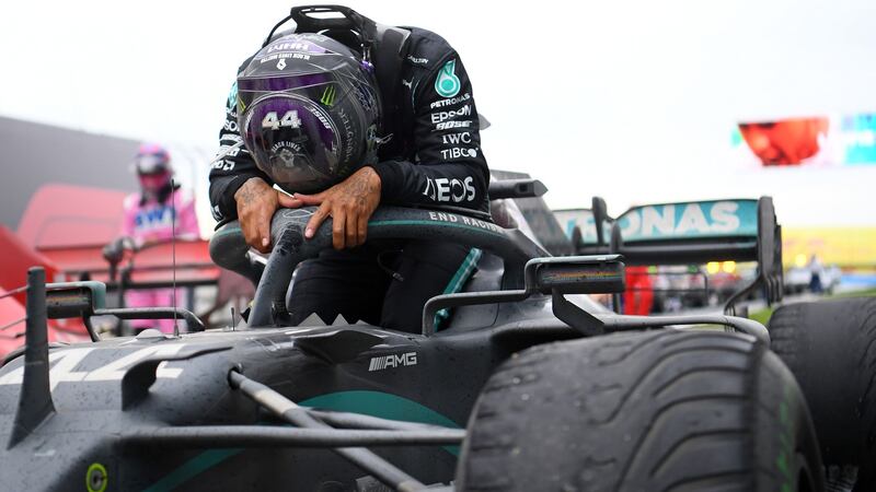 Lewis Hamilton gets out of his car after securing the world championship. Photograph: Clive Mason/Getty/AFP