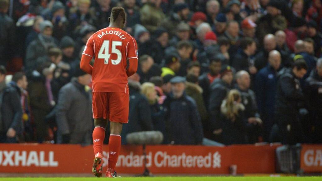 Liverpool’s Mario Balotelli leaves the pitch as his teammates celebrate after the English Premier League soccer match between Liverpool FC and Tottenham Hotspur at Anfield in Liverpool - he was the hero last night. Photograph: Peter Powell/EPA