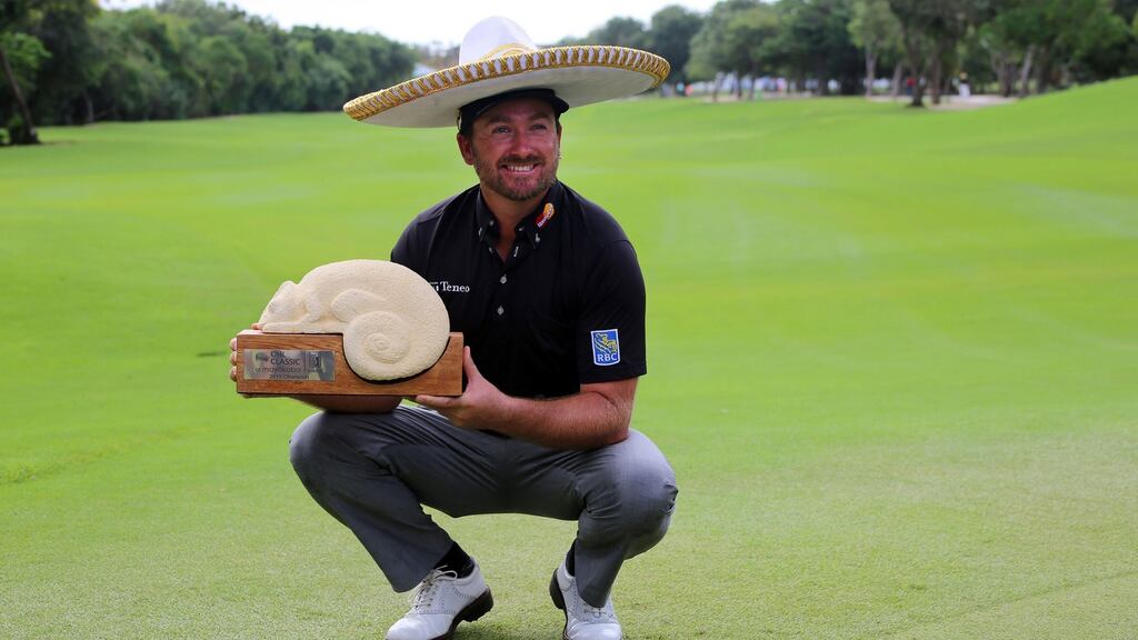 Graeme McDowell poses with the trophy after his victory in the Mayakoba Classic in Mexico. Photograph: Alonso Cupul/EPA