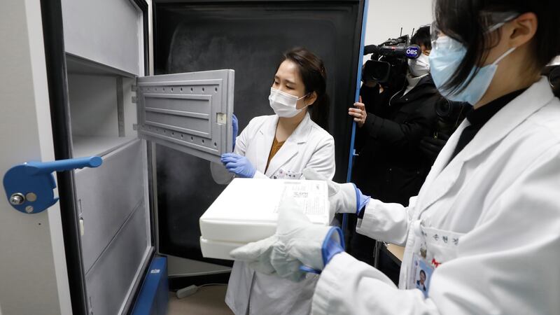 Medical workers store mock vaccines against the new coronavirus in a cryogenic freezer at the National Medical Center in Seoul, South Korea on Wednesday as South Korea conducts a drill to distribute the vaccines in a safe manner ahead of the vaccination of the whole nation starting this month. Photograph: Yonhap/EPA
