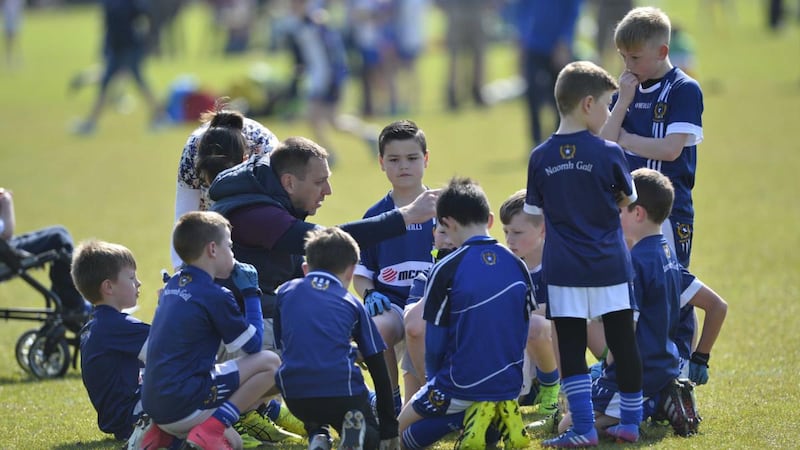 Team manager Pádraig Ó Muirigh with the St Gall's under-10 footballers [current under-15 team) at half-time during the annual Mayday tournament at De La Salle park in Belfast in 2017. Photograph: Mark Marlow