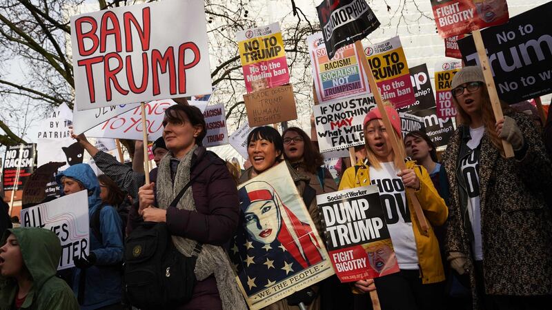 Demonstrators holding placards take part in a protest against US President Donald Trump outside the US Embassy in London. Photograph: Niklas Halle’n/AFP/Getty Images