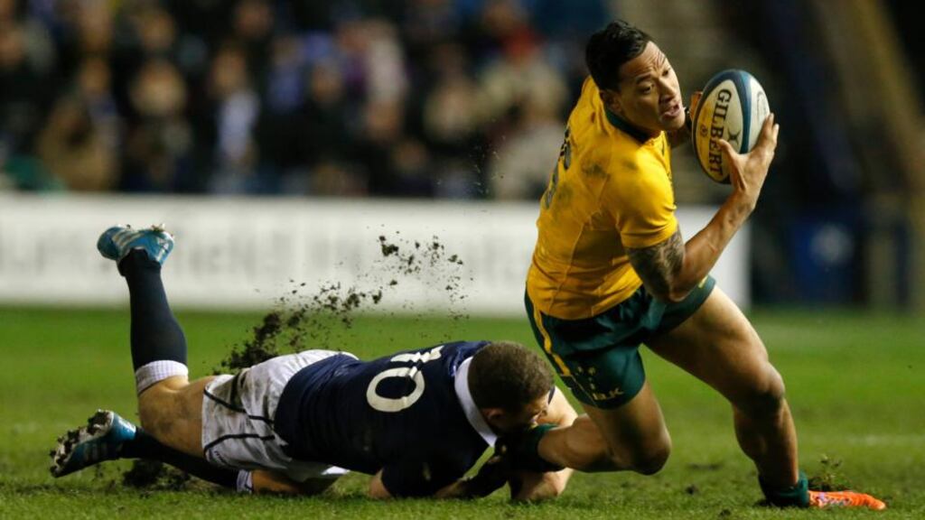 Australia’s Israel Folau is tackled by Scotland’s Duncan Weir. Photograph: Russell Cheyne/Reuters