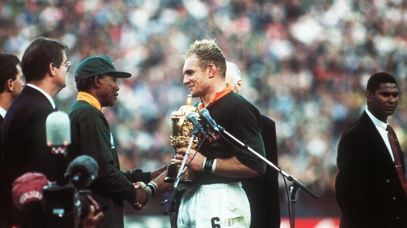 Francois Pienaar receives the Webb Ellis Cup from Nelson Mandela after the 1995 RWC final. Photograph: Inpho/AllSport
