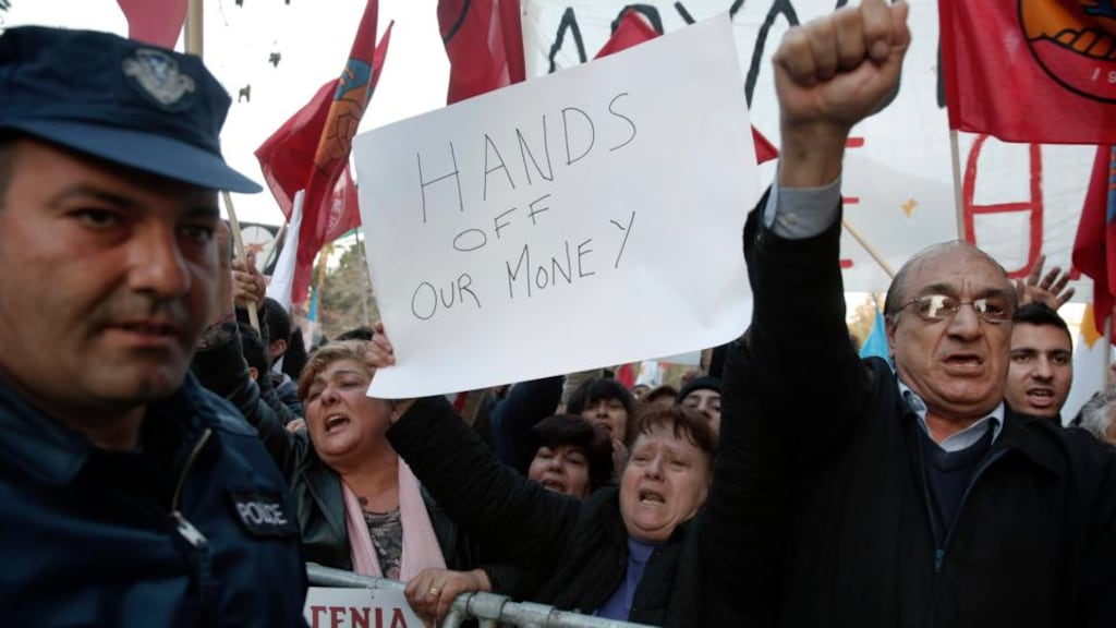 Protesters shout slogans during an anti-bailout rally outside the parliament in Nicosia yesterday. Photograph: Yorgos Karahalis/Reuters