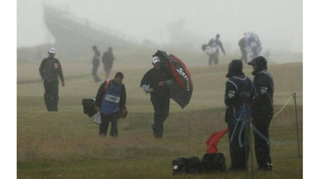 Shane Lowry braves the elements as he put the finish touches to his preparations earlier today. Photograph: Shaun Best / Reuters