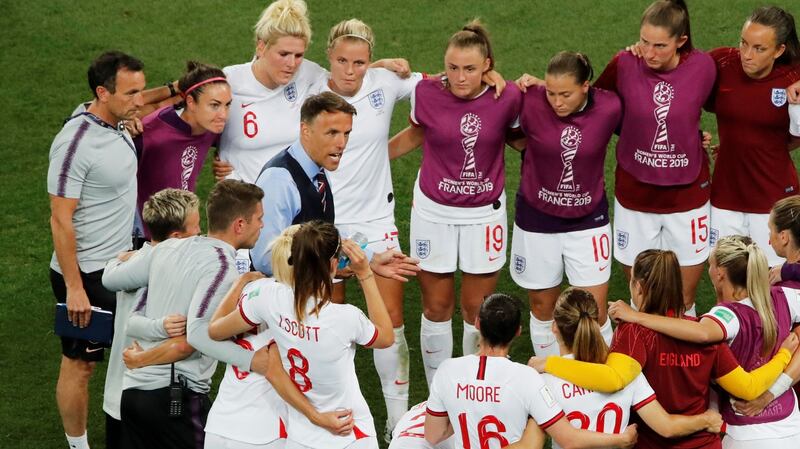 Phil Neville speaks to his side after their 2-0 win over Japan. Photograph: Jean-Paul Pelissier/Reuters