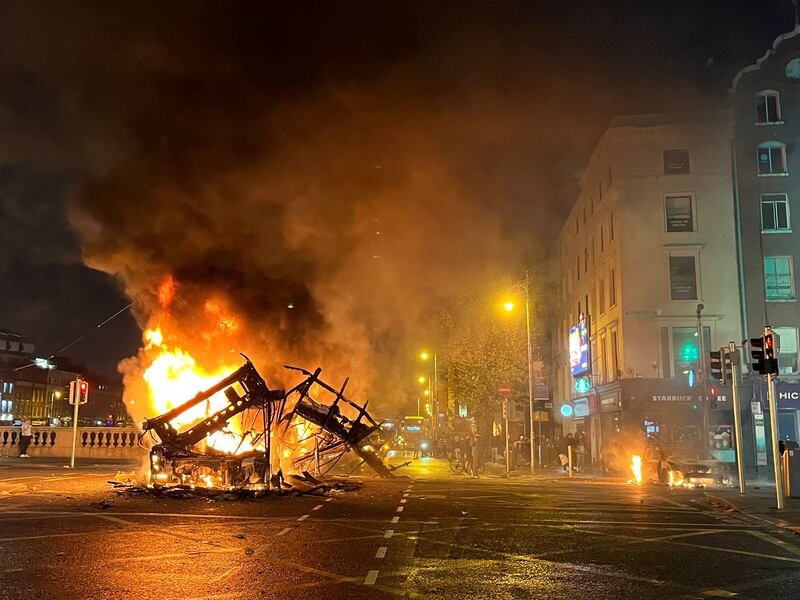 The remains of a bus ablaze on O'Connell Street in Dublin during violent disorder in the wake of a stabbing incident on Parnell Square. Photograph: Jack Power/The Irish Times
