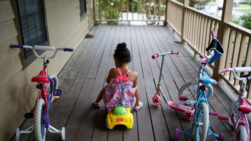 Zai Deshields (4) plays at home before her first therapy session, in Stone Mountain, Georgia. Her mother says she has become withdrawn and regressed to baby-talk since recently pulling a handgun out of a backpack while visiting her grandmother in Texas and wounding her uncle in the leg. Photograph: Melissa Golden/The New York Times