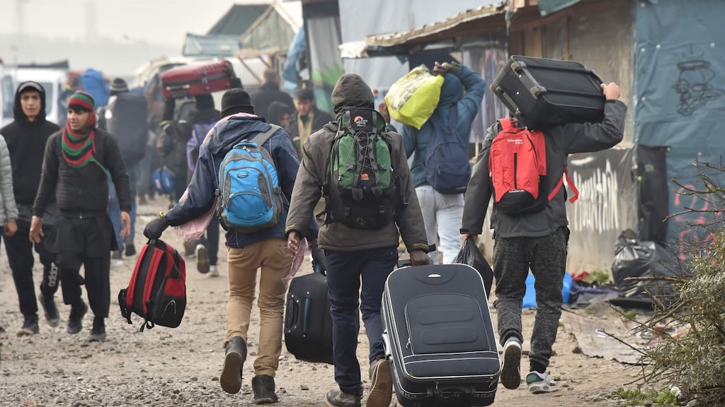 Migrants with their suitcases in the Calais Jungle camp. Photograph: Philippe Hugen/AFP/Getty