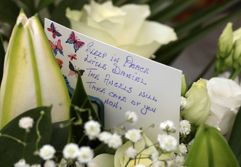 Flowers and a card left to the memory of Daniel Aruebose. Photograph: Collins