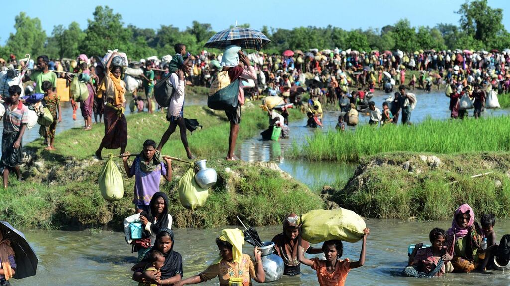 Rohingya refugees walk through a shallow canal after crossing the Naf River as they flee violence in Myanmar to reach Bangladesh in Palongkhali near Ukhia in 2017. Photograph: Munir Uz Zaman/AFP via Getty