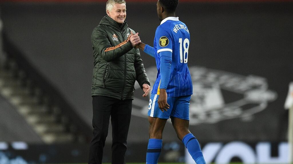 Manchester United manager Ole Gunnar Solskjær greets Danny Welbeck of Brighton  earlier this month, with the new black banners in the stands at Old Trafford in the background. Photograph: Oli Scarff/Getty Images